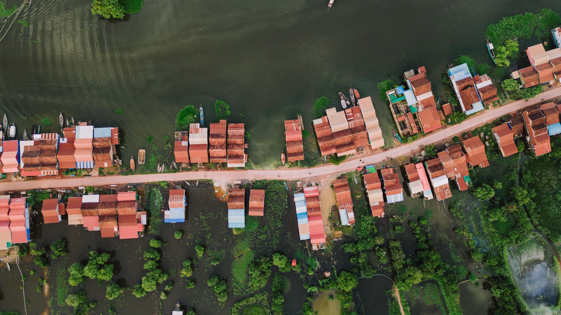 Scenic aerial view of Kampong Khleang floating village with colorful stilt houses in Cambodia.
