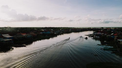 Free Aerial view of boats navigating the river in Kampong Khleang, Cambodia at sunset. Stock Photo