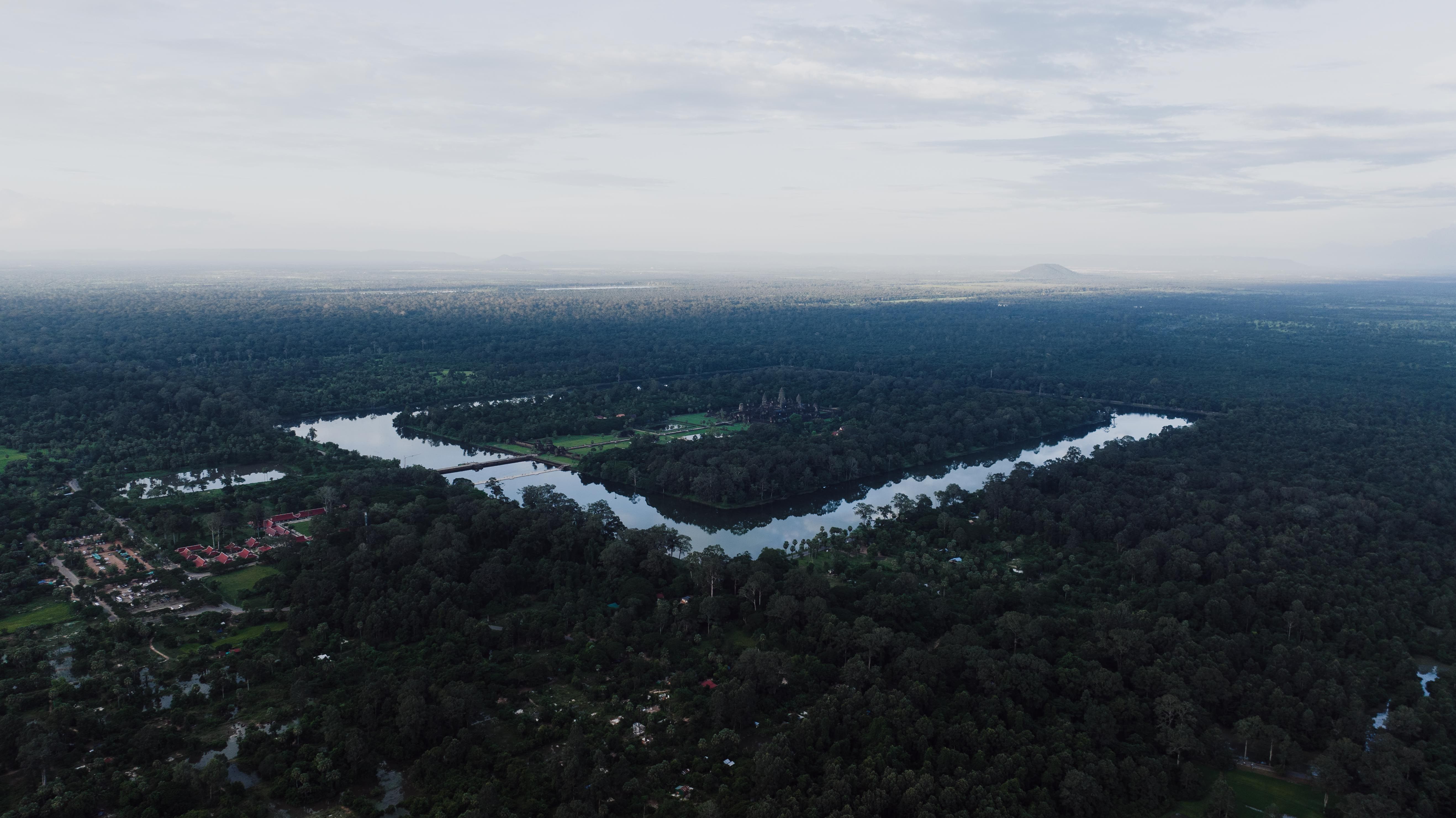 Stunning aerial view of Angkor Wat, Cambodia, surrounded by lush forests and serene waterways.