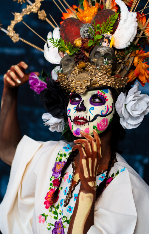 Free Colorful portrait of a woman with Day of the Dead makeup and floral headpiece. Stock Photo