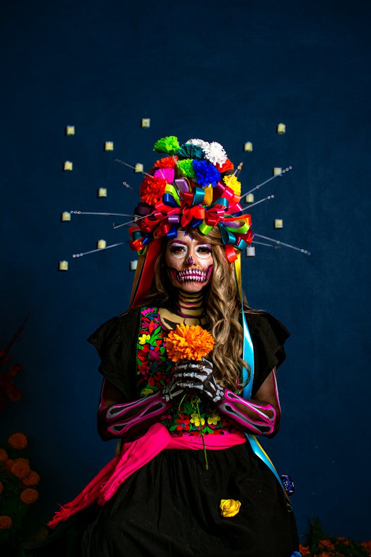 Woman In Mexican Halloween Costume Holding Flowers