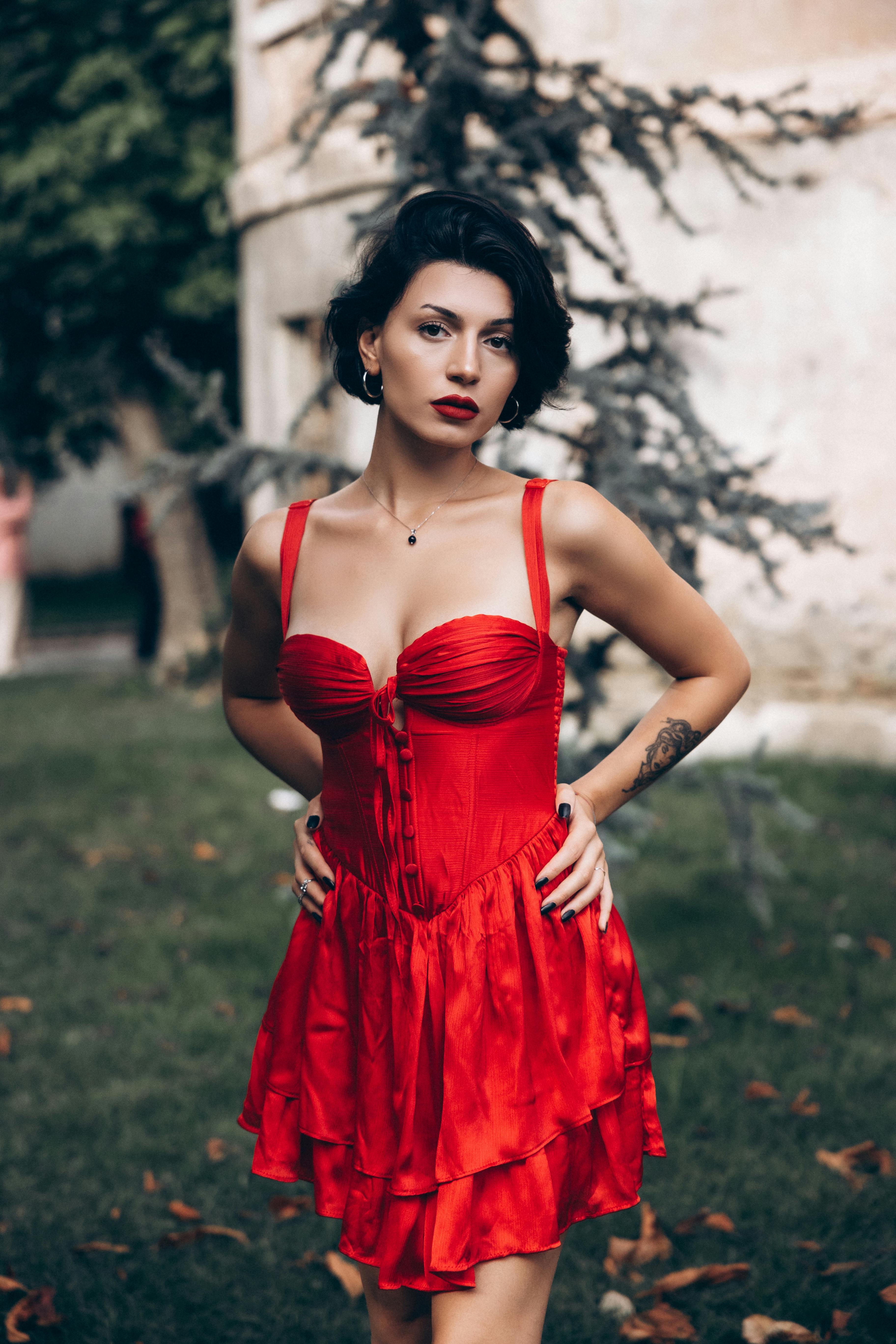 a woman in a red dress posing for the camera