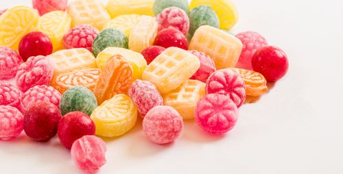 Free A vibrant display of assorted colorful hard candies on a white background. Stock Photo