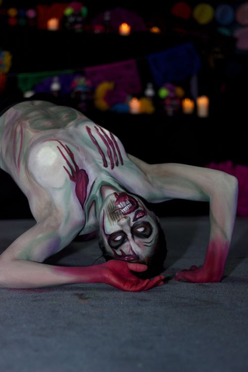 Free A person performs a bend with elaborate zombie makeup for Halloween, creating a spooky scene. Stock Photo
