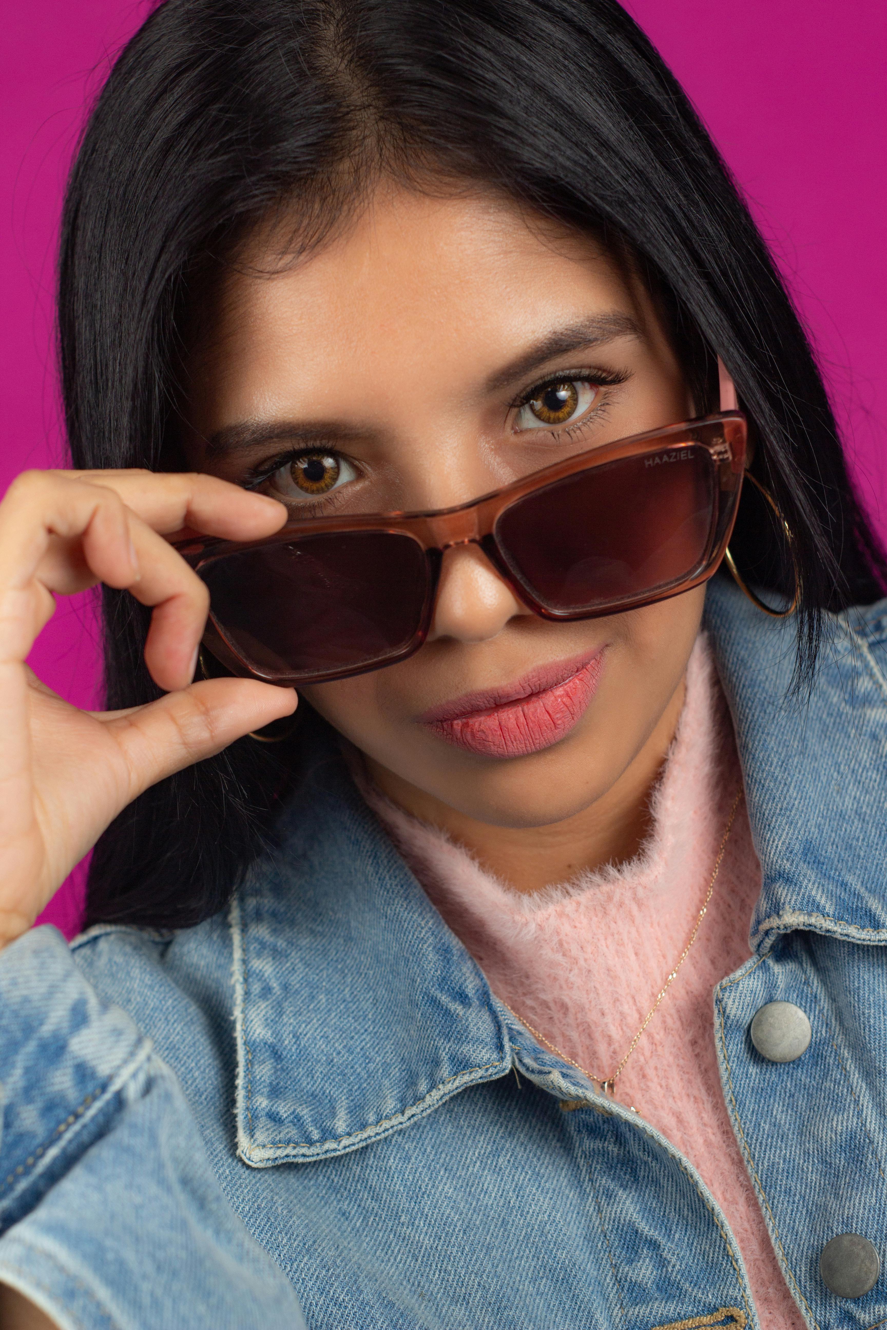 Face of winking joyful woman looking over sunglasses Stock Photo - Alamy