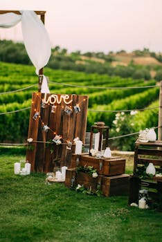 Charming rustic wedding setup with wooden accents and candle decor in a vineyard setting.