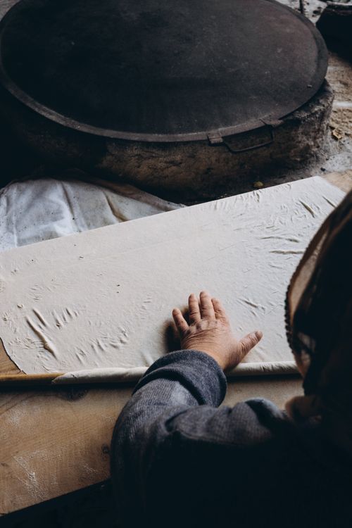 Free Close-up of a senior woman kneading dough indoors, showcasing traditional baking techniques. Stock Photo