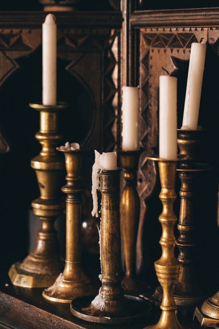 Ornate vintage brass candlesticks with lit candles — photo by Gizem Çelebi on Pexels