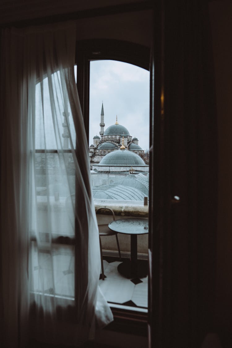 Mosque Minaret And Domes Behind Windows In Istanbul