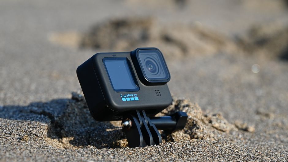 Close-up of an action camera placed in sand on a sunny day in Bali, Indonesia.