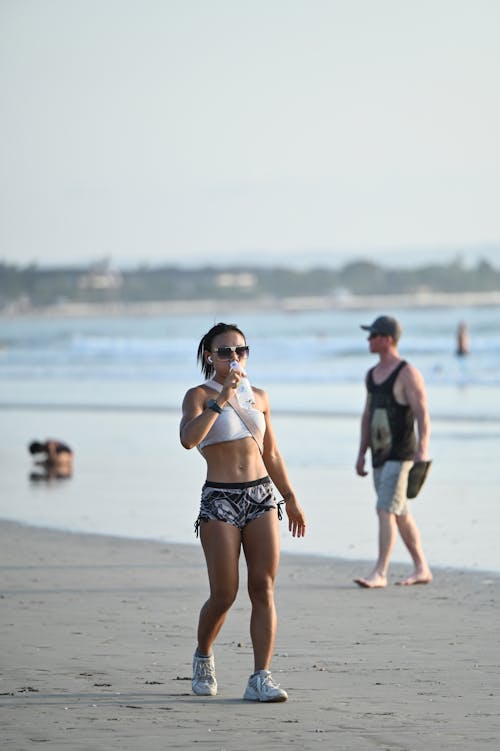 Woman in Sportswear Walking on Beach