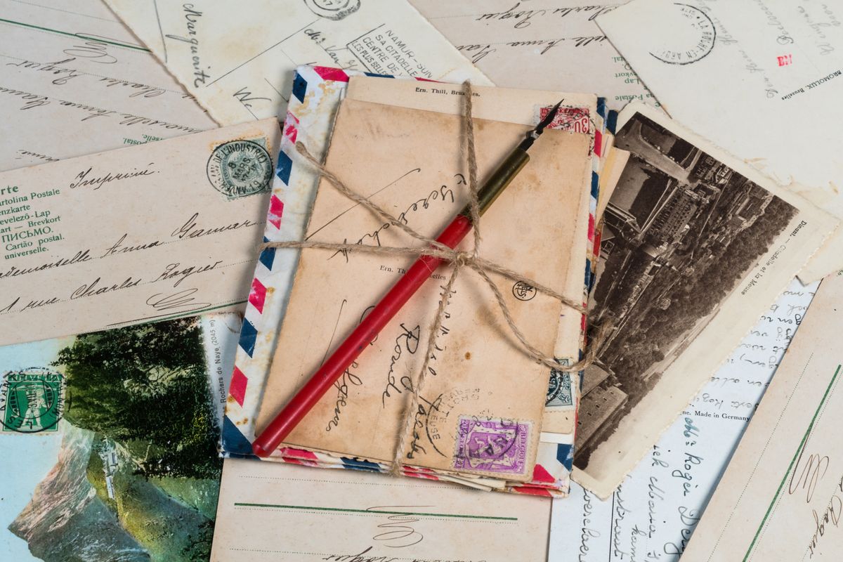 A bundle of old letters and envelopes tied with twine - How the Book Is Built