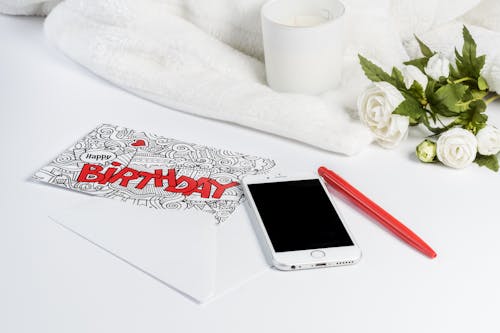 Free Silver Iphone 6 Beside Red Pen Stock Photo