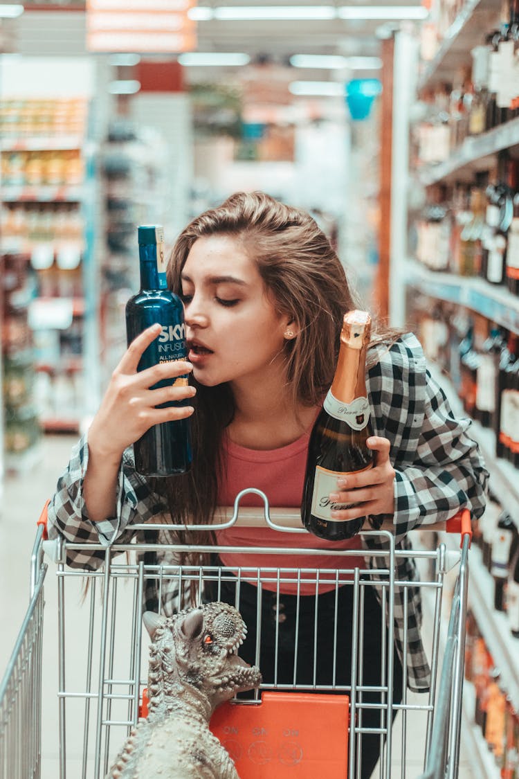 Woman Buying Alcohol In A Market 