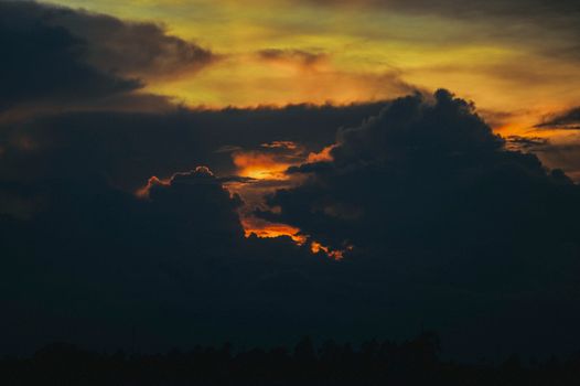 A stunning and dramatic sunset with vibrant skies and dark clouds forming a dramatic scene.