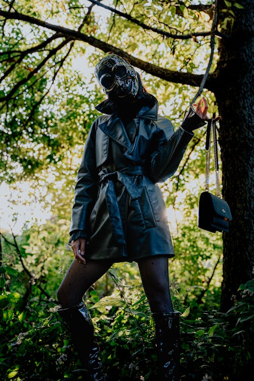 Person in Jacket and Mask in Forest