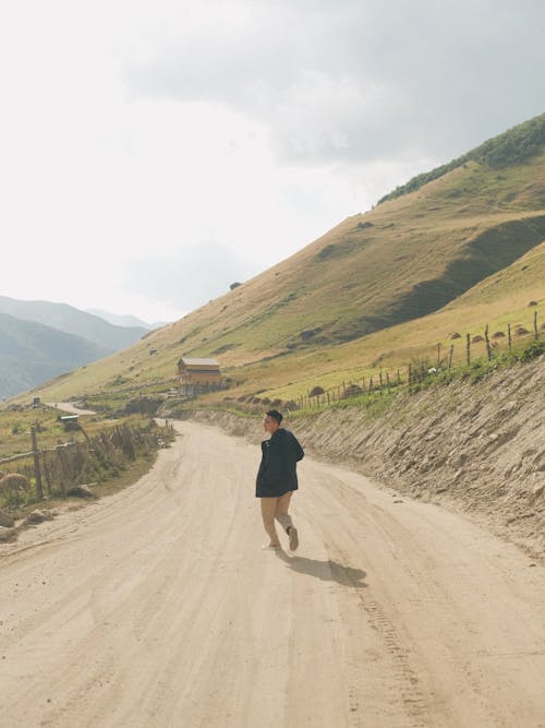 Man on Dirt Road in Mountains