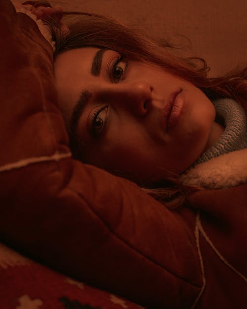 Close-up Photo of Woman in Jacket Lying Down