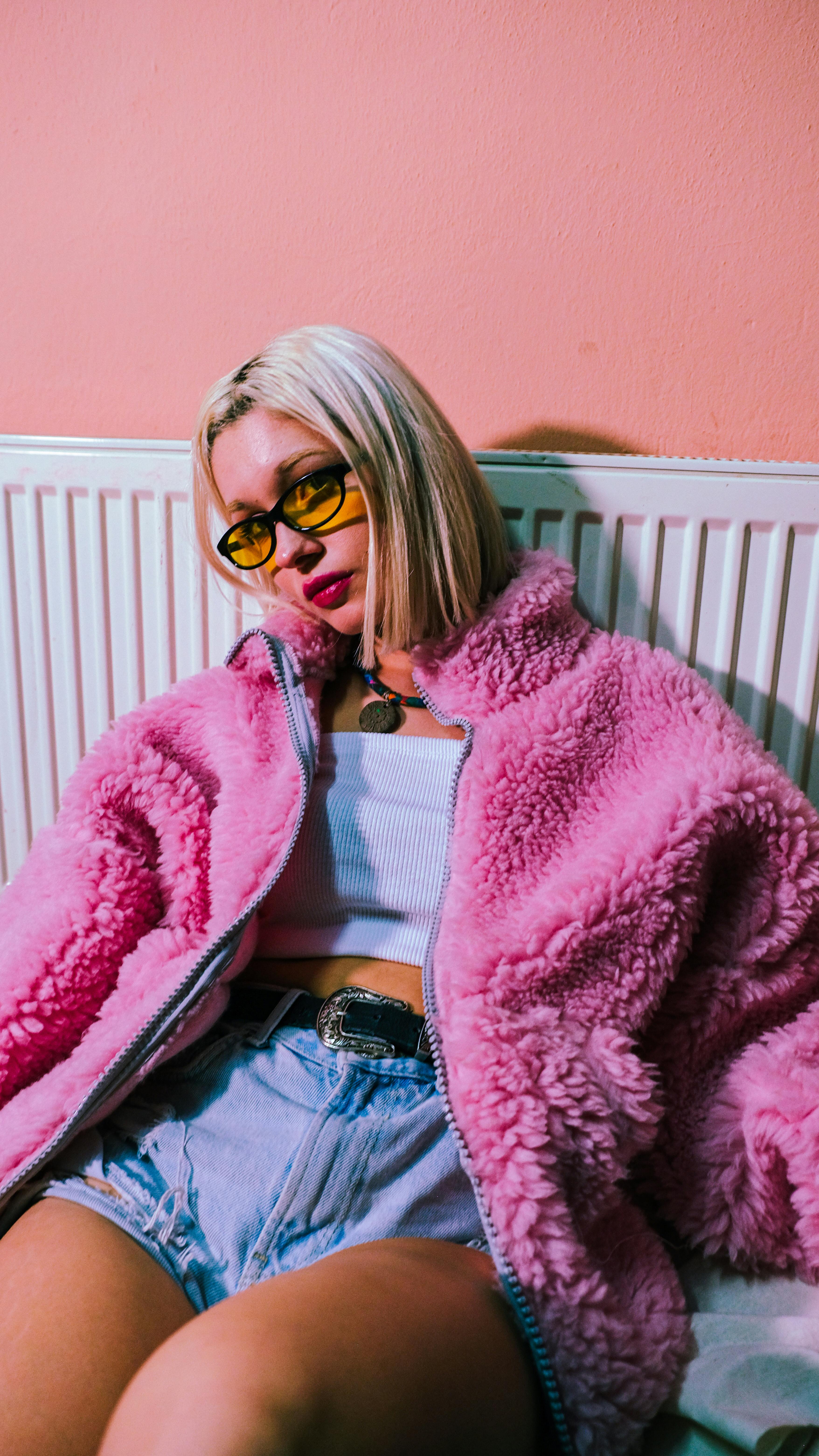 Young Woman Posing in a Fuzzy Pink Jacket Free Stock Photo