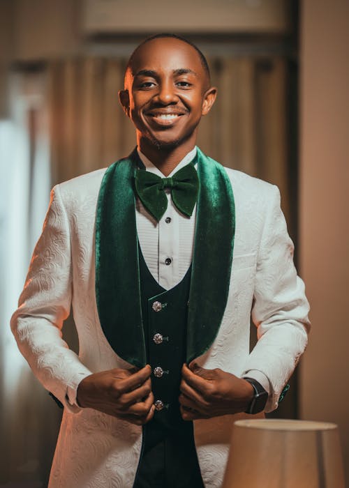 Smiling Man in Elegant White and Green Tuxedo