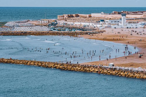 Free Aerial view of a crowded beach with people enjoying the summer by the sea. Stock Photo