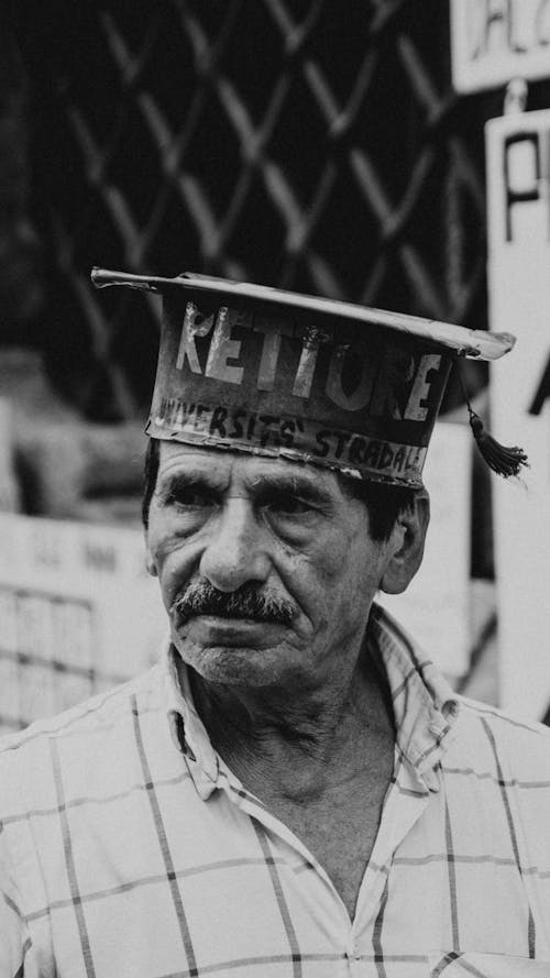 Grayscale Photo of Man Wearing Cap