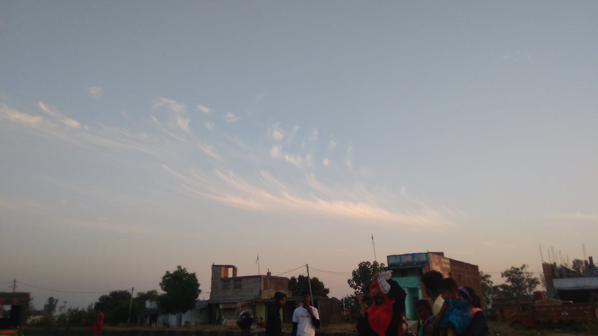 A forward controlling the ball under pressure from defenders in a football match