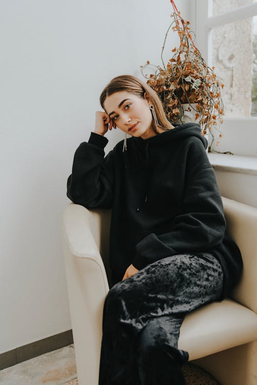 Woman Sitting Beside Window