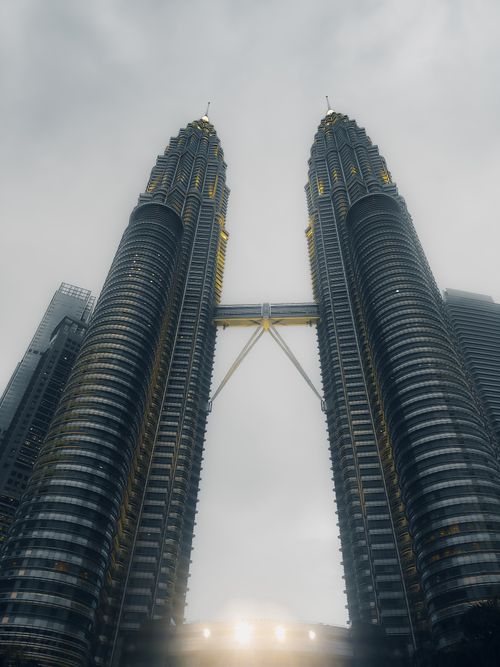 Free Stunning vertical shot of the Petronas Towers in Kuala Lumpur, Malaysia against a cloudy sky. Stock Photo