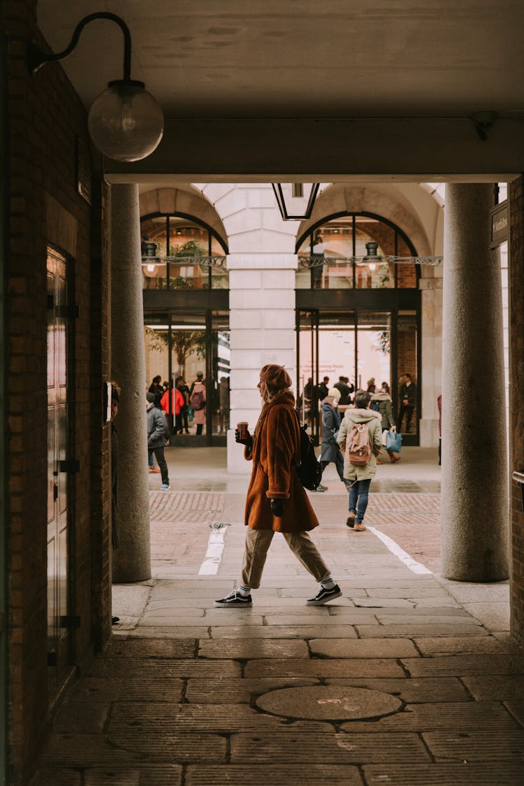 Woman Walking Through Building