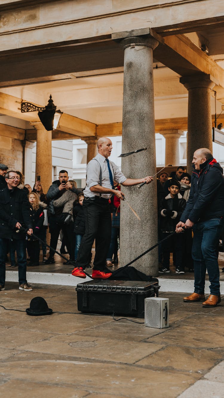 Group Of People Looking At A Man 