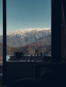 Relaxing view of snowy mountains from a luxurious indoor bathtub, perfect for unwinding.