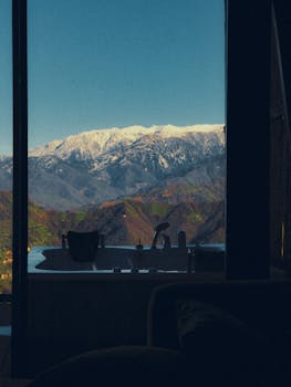 A luxurious bathtub overlooks the snowcapped mountains, offering a serene mountain escape