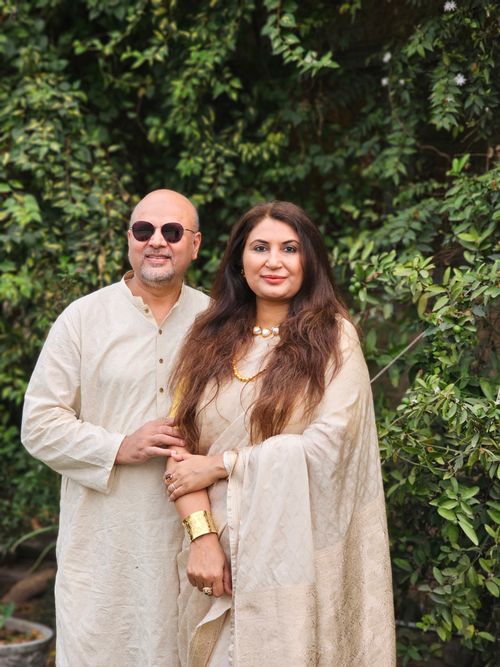 Free A couple in traditional dress posing outdoors, showcasing elegance and style. Stock Photo