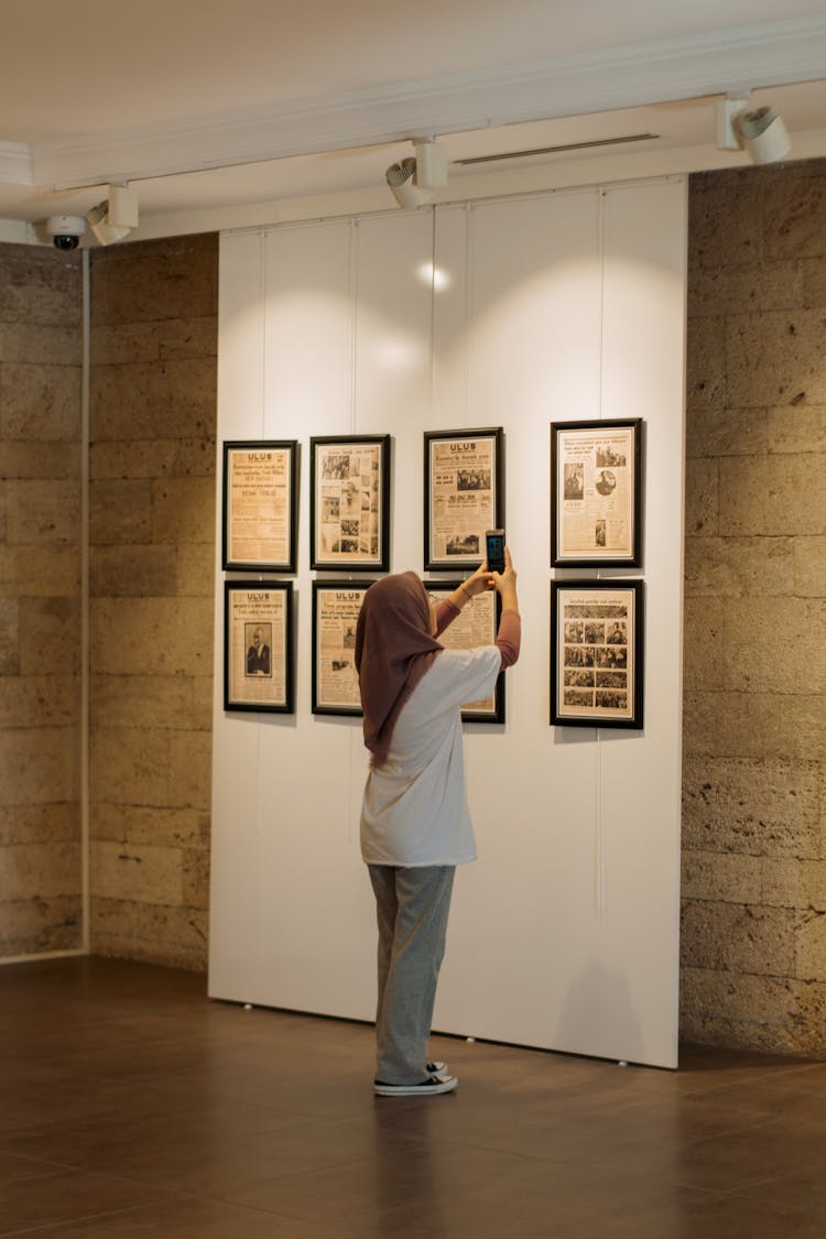 Woman Taking Pictures In A Museum 