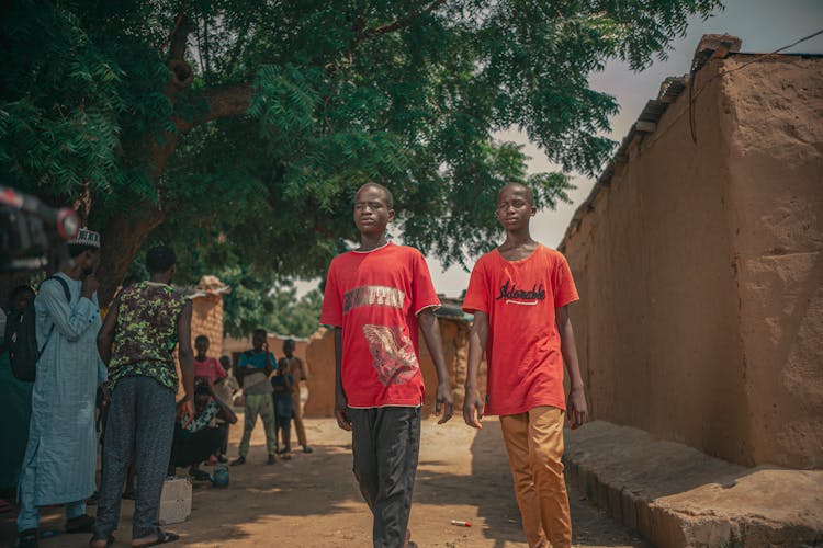 Teenage Boys Walking In A Town In Africa