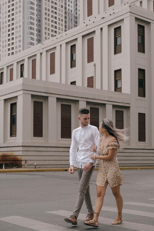 Couple Crossing Street in City