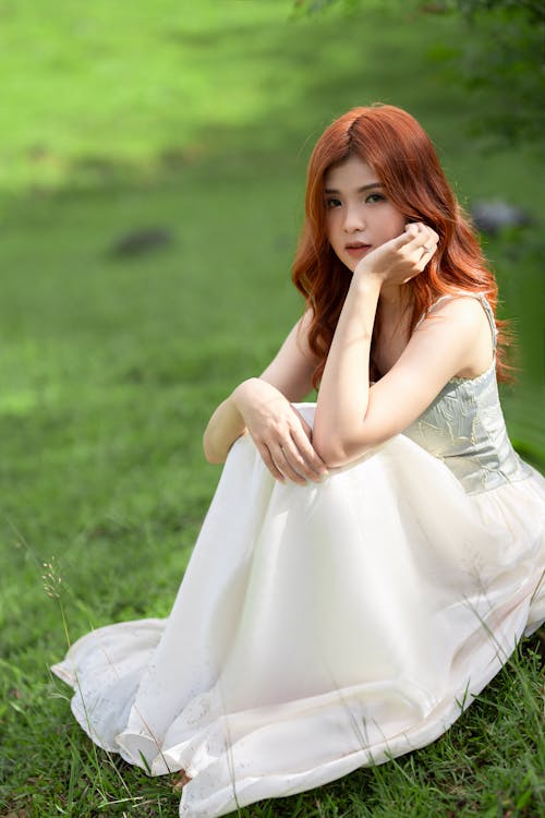 Redhead Woman in White Maxi Dress on Grass