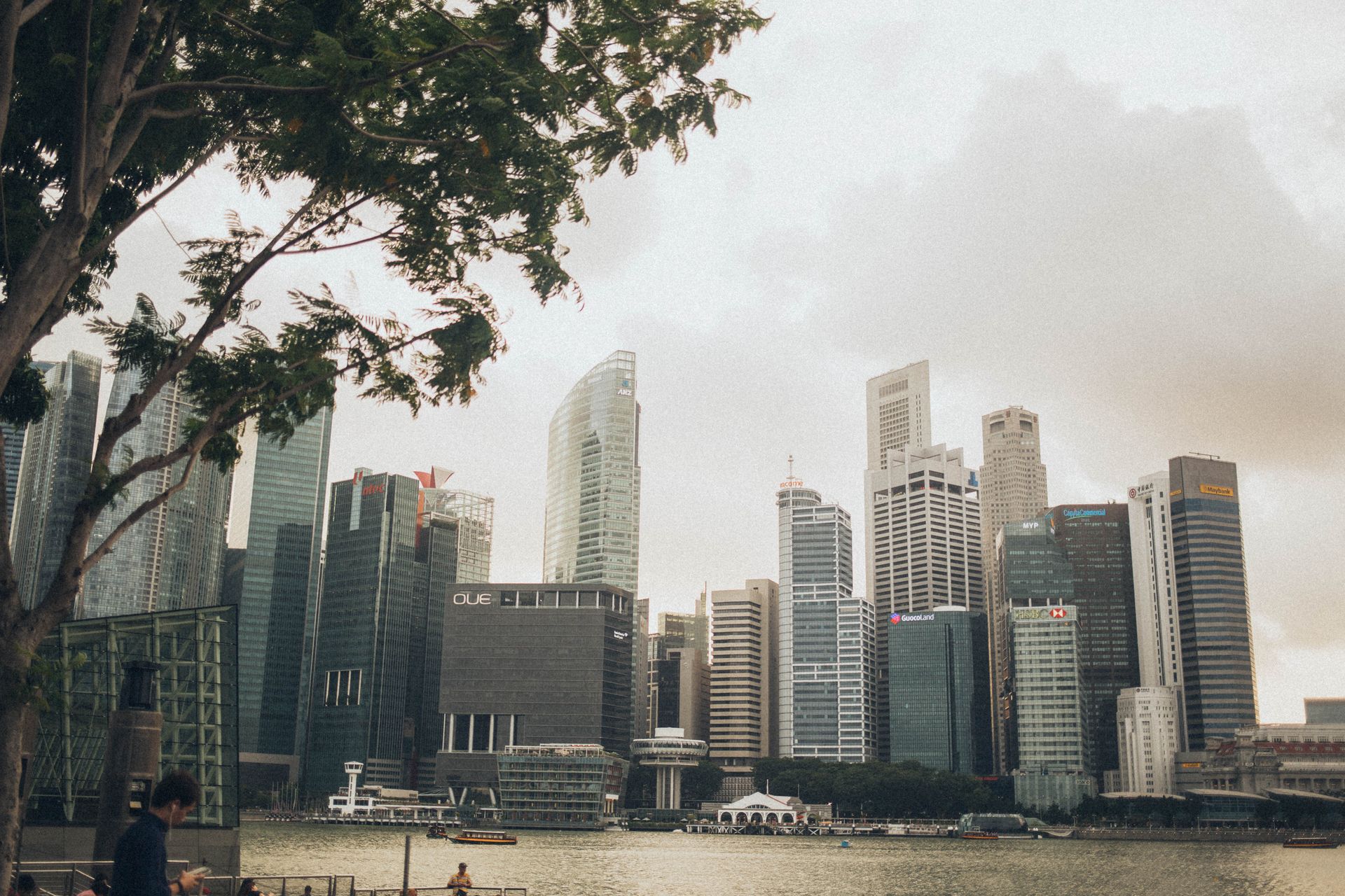 View of Singapore's modern skyline and financial district with skyscrapers by the waterfront.