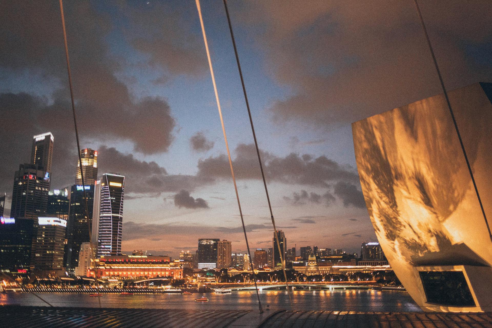 Beautiful Singapore skyline at dusk with illuminated skyscrapers and waterfront view.