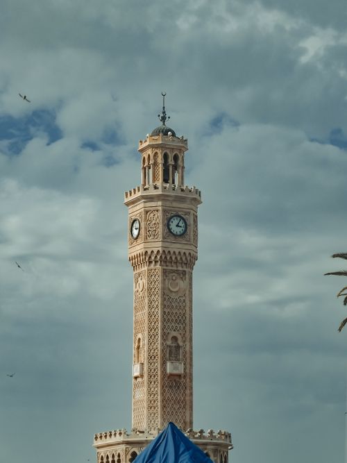 Free A vertical shot of the historic Izmir Clock Tower set against a dramatic cloudy sky. Stock Photo