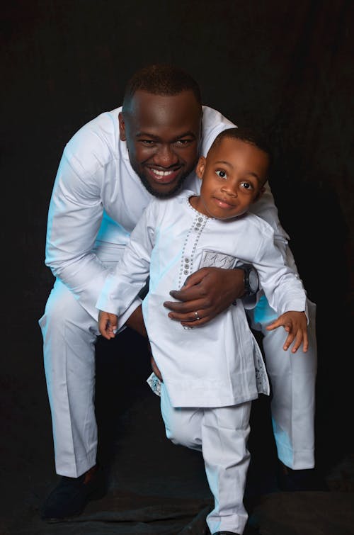 Smiling Father with Son in Traditional Clothing