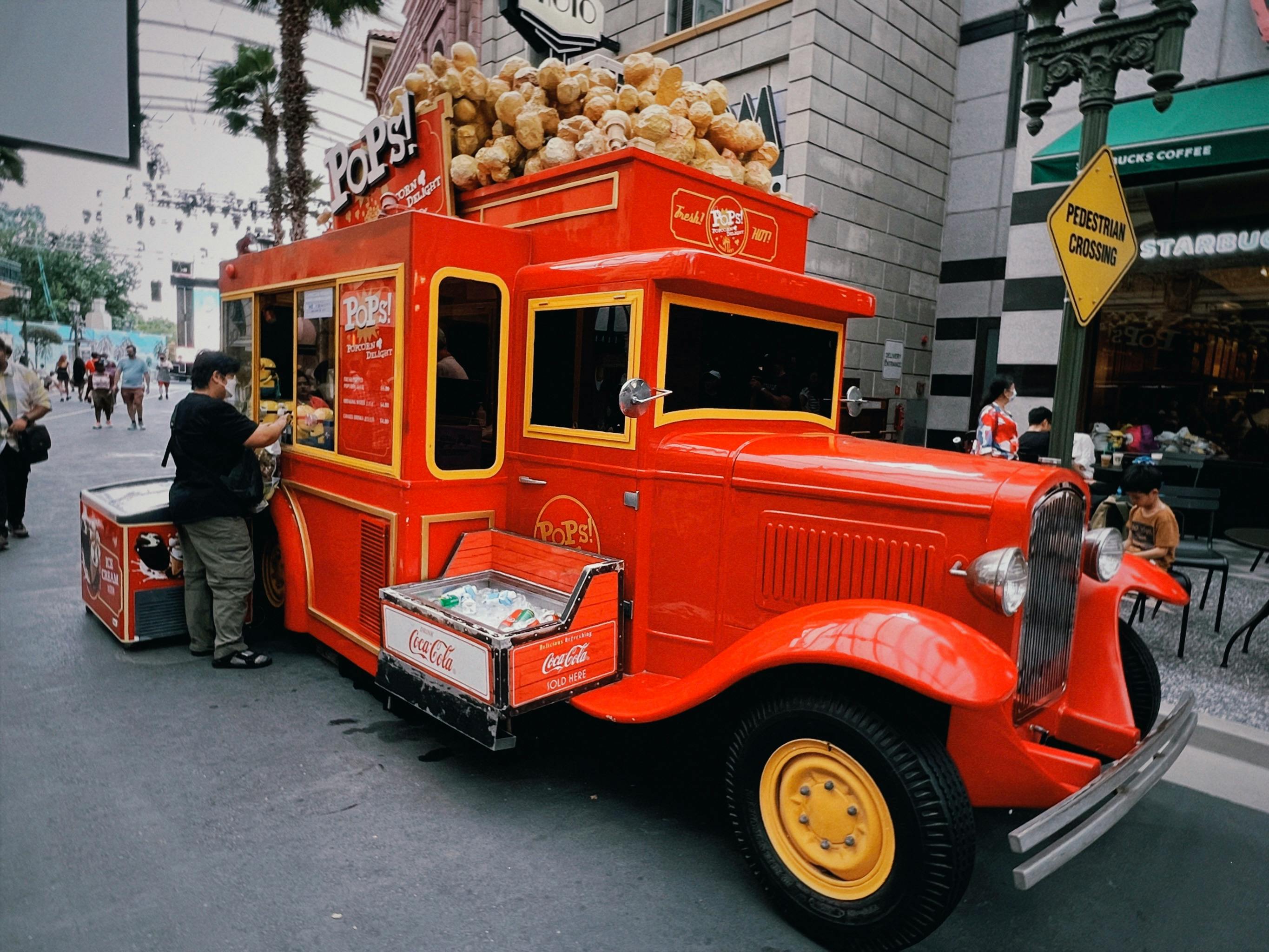 A Vintage Red Truck Selling Popcorn on the Street in City · Free Stock Photo