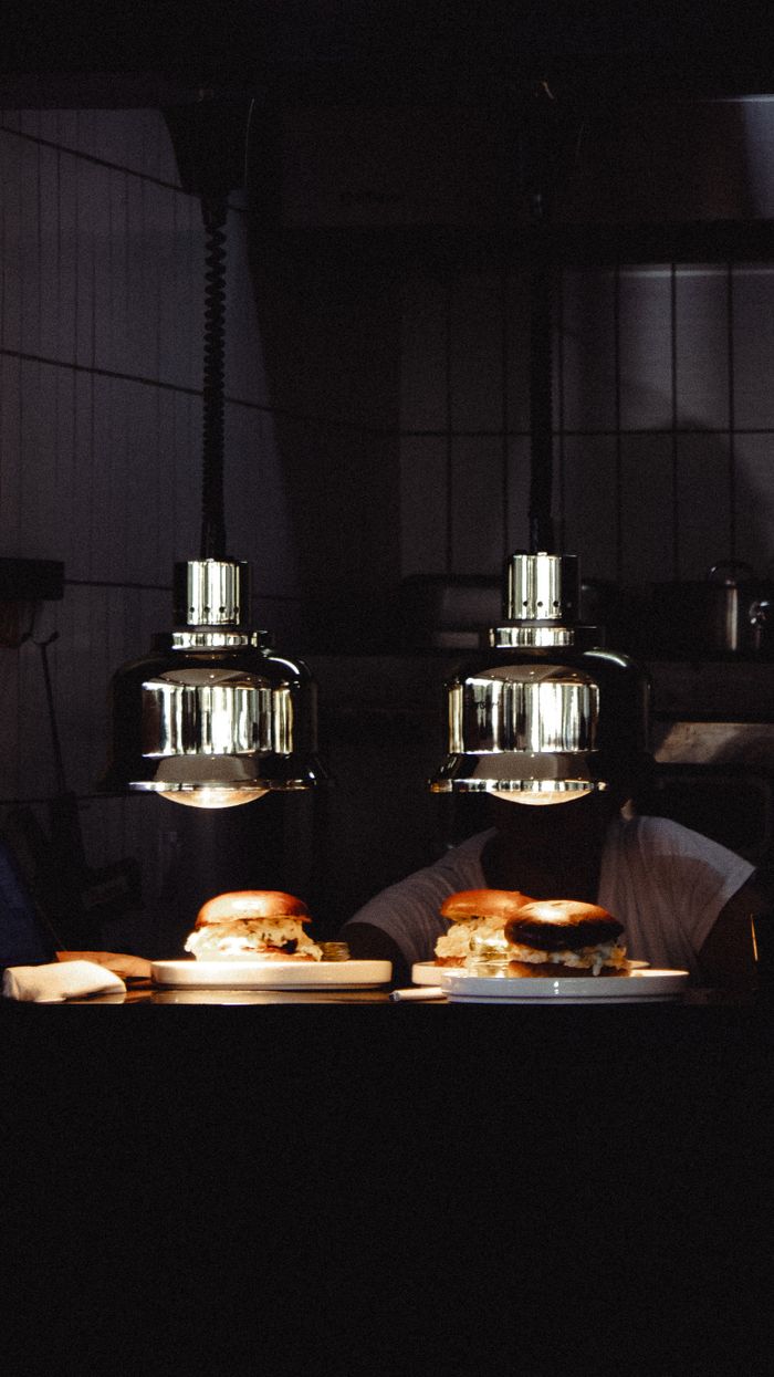 Burgers served under stylish hanging lamps
