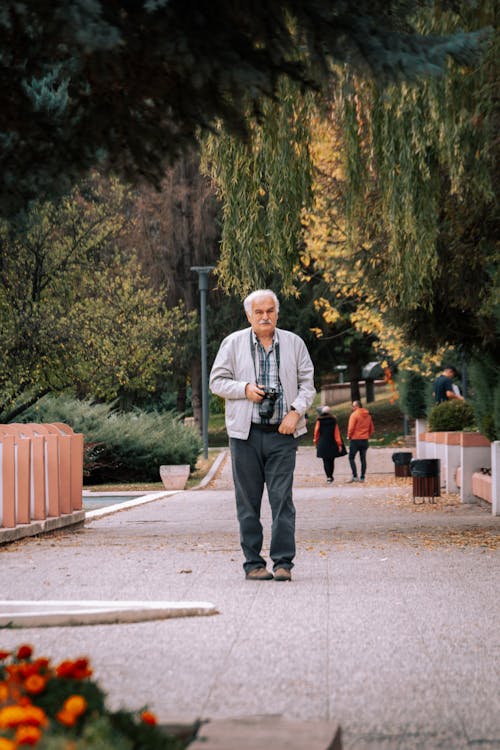 Elderly Man with Camera in Park