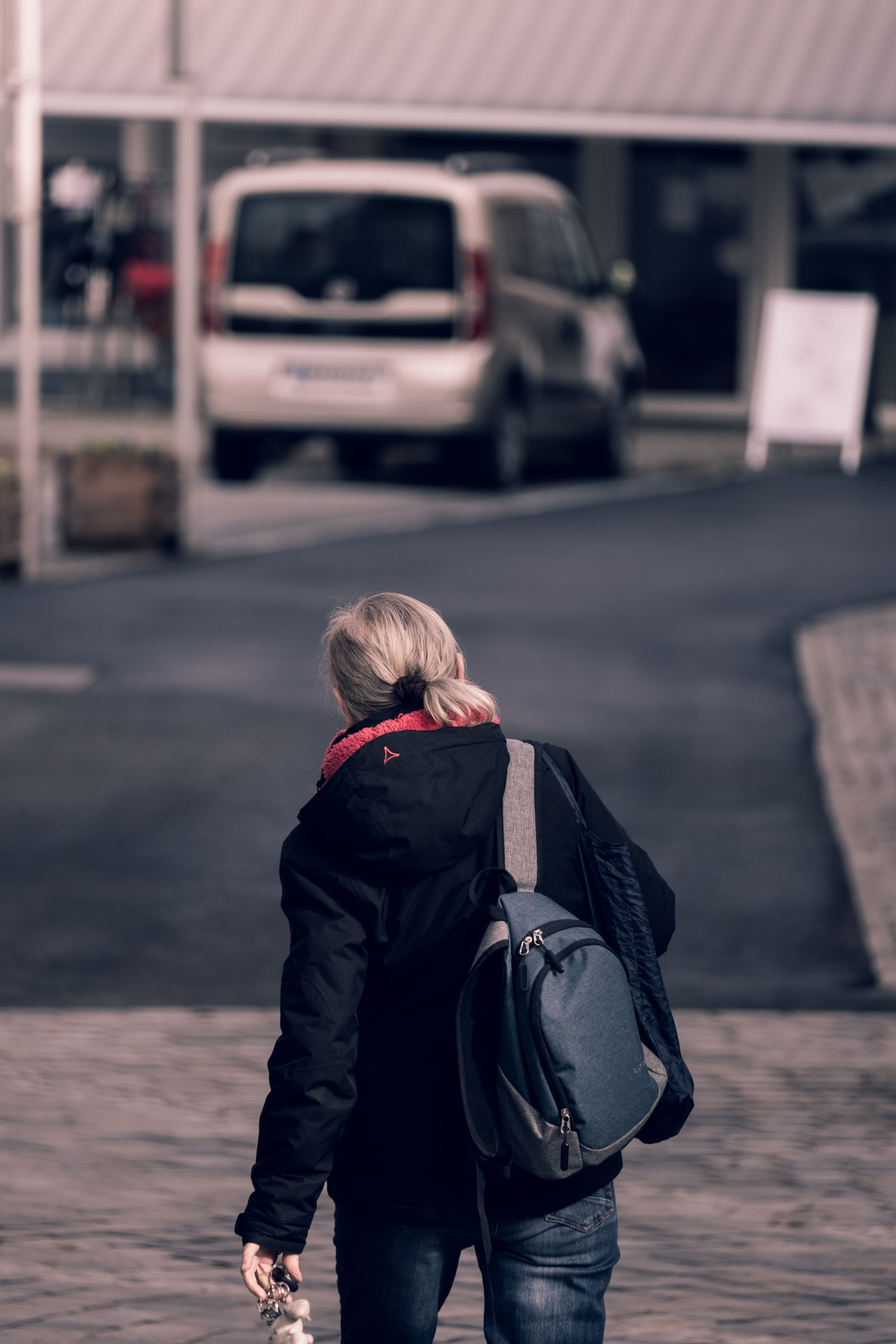 Blonde Woman with Backpack Walking on Street · Free Stock Photo