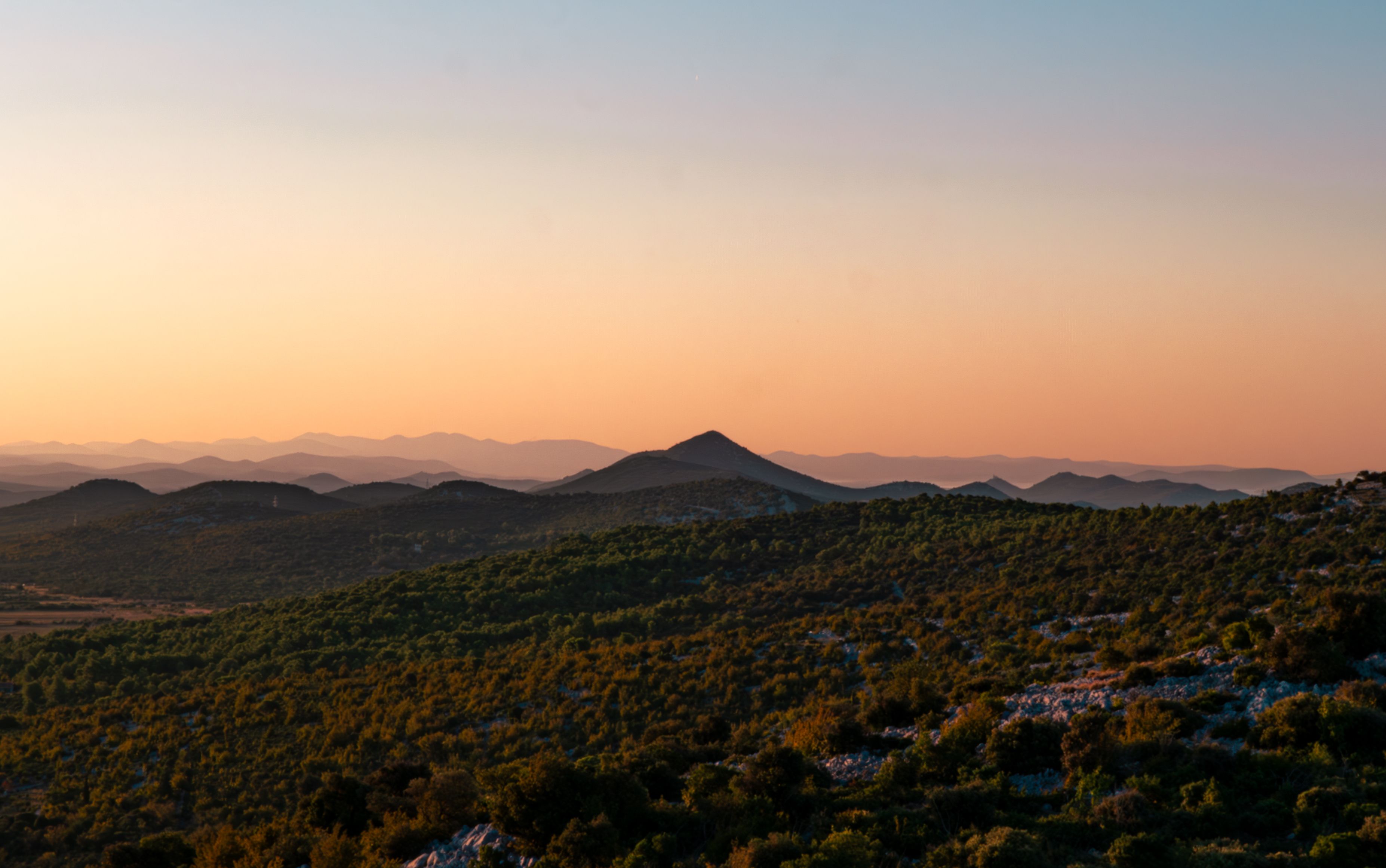 A captivating sunrise over Bribir, Croatia, showcasing serene mountains and lush greenery.