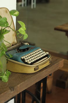 Old typewriter with lush ivy in a cozy indoor scene, perfect for retro nostalgia.