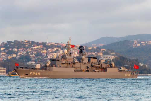 Free Turkish naval warship F240 cruising in the Bosphorus against an Istanbul cityscape. Stock Photo