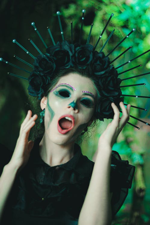 Woman in a Halloween Costume and Makeup Wearing Black Dress and Crown